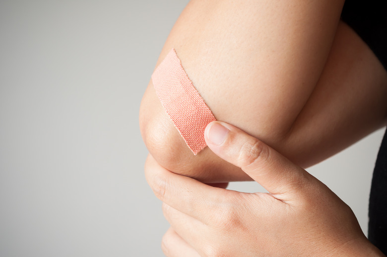 Elbow with adhesive bandage