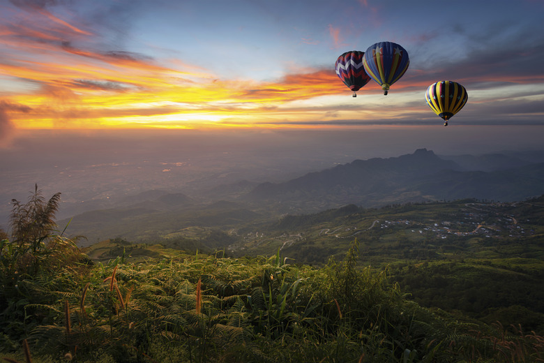 Hot air balloon flying over Phu Tab Berk hill in morning