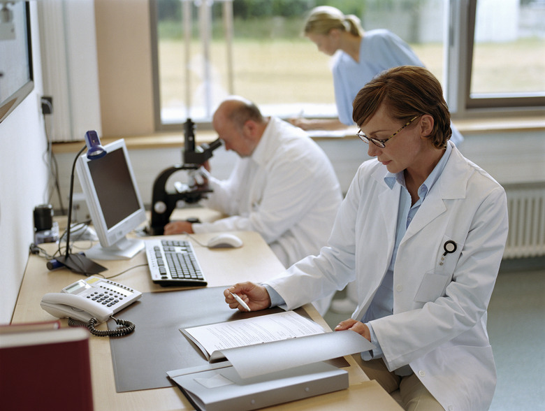 Female doctor sitting in office, portrait