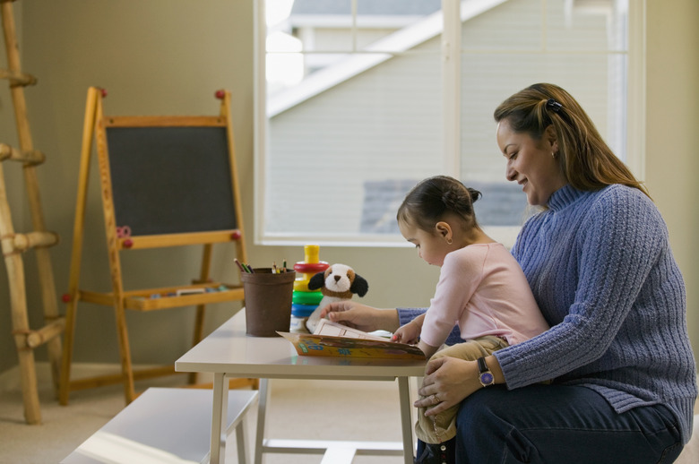 Hispanic mother and daughter doing art