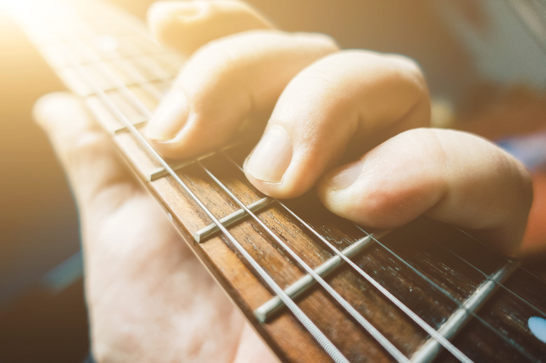 Cropped Hand Holding Guitar