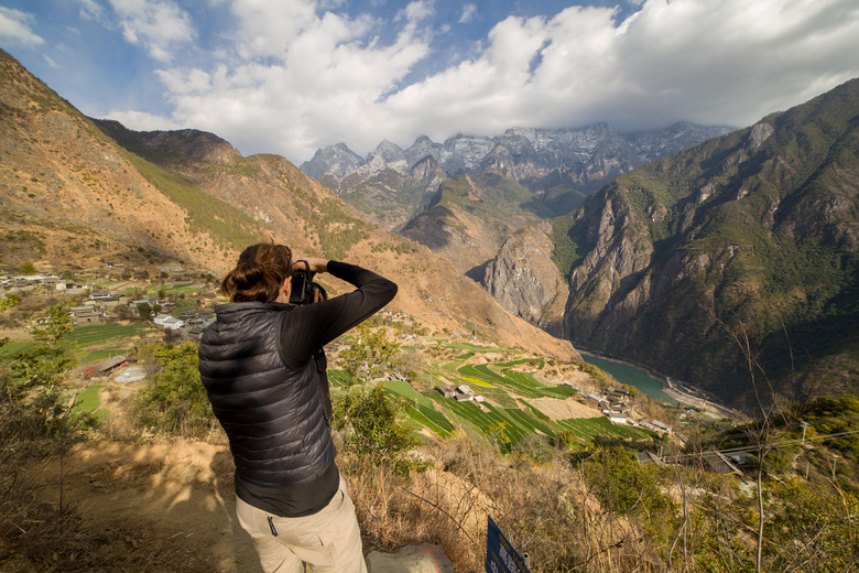 Man photographing The Tiger Leaping Gorge, China