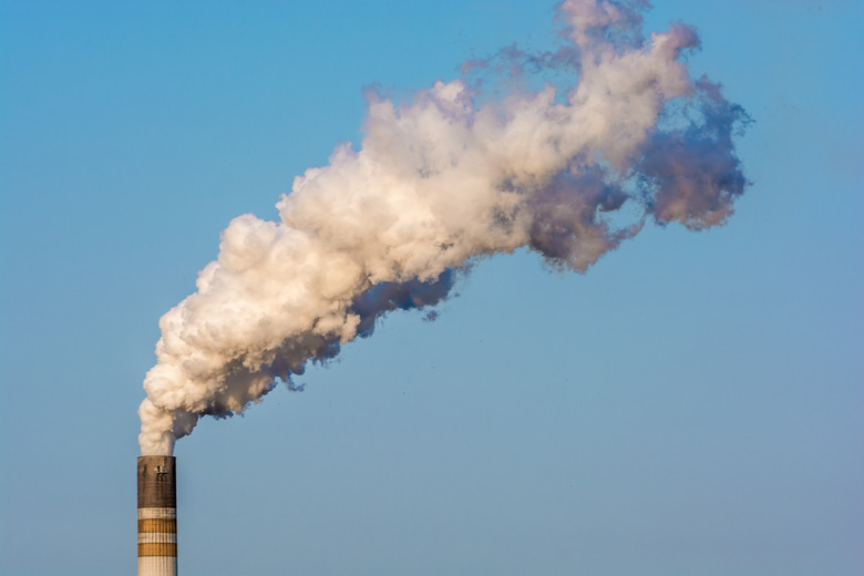 Highly smoking chimney against a blue sky