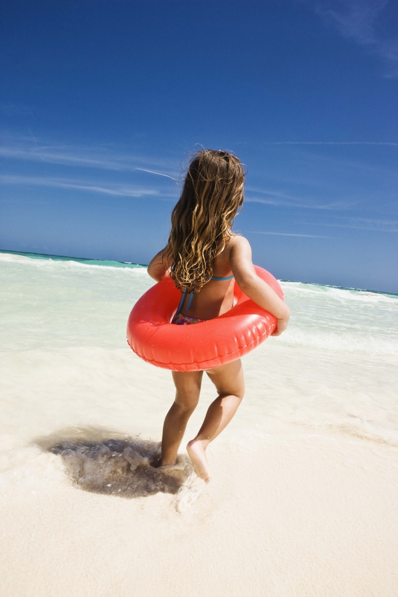 Girl with flotation device at the beach