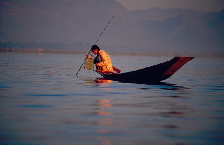 Person Fishing off Tiny Boat