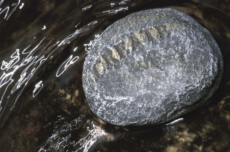 Stone with create carved on it