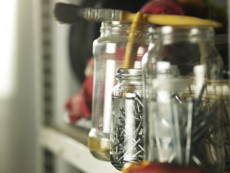 Shelf of recycled jars with nails