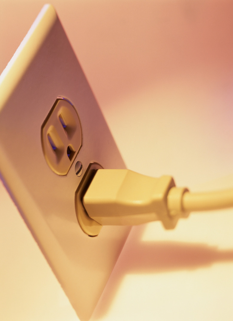 close-up of a plug plugged into an electrical wall socket