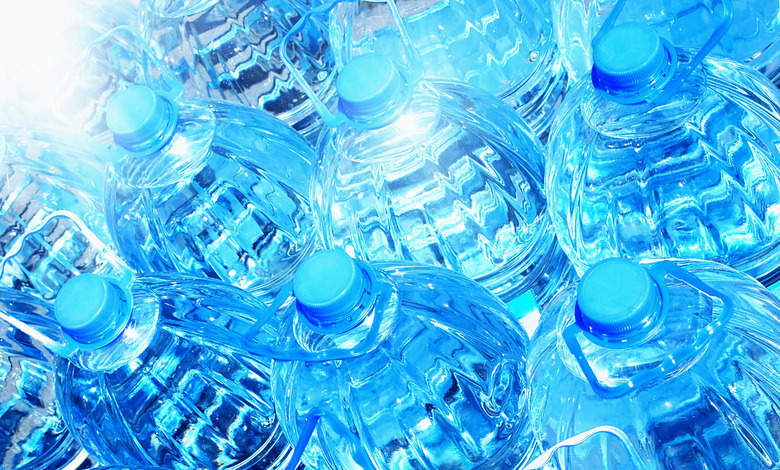 Frame-filling group of blue plastic bottles of water