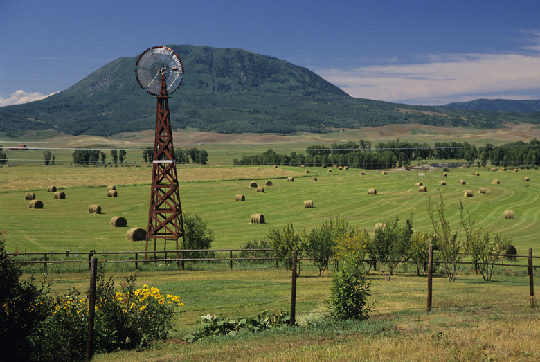 Windmill and haystacks on farm, Steamboat  Springs, Colorado, USA