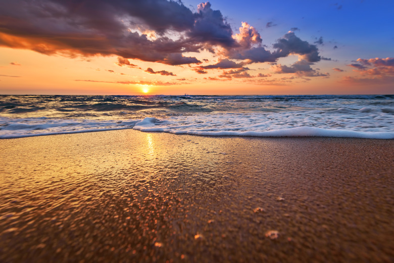 Early morning, sunrise over sea. Golden sands.