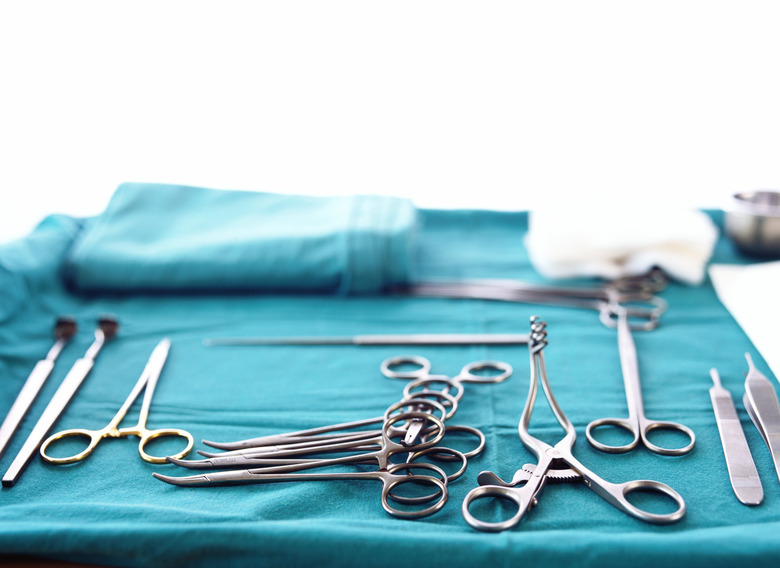 an array of clean surgical instruments lying on fresh scrubs