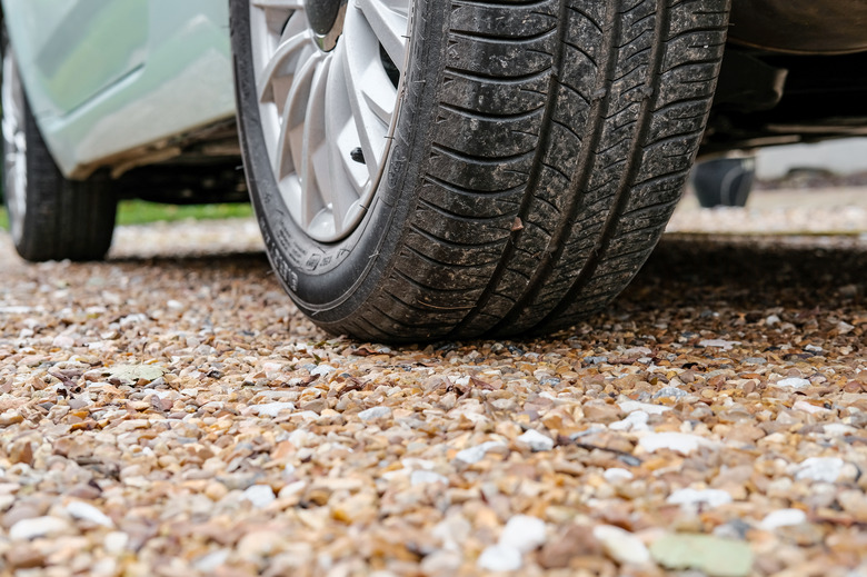 Ground level view of a new car, showing the rear tyre and tread together with the alloy wheel