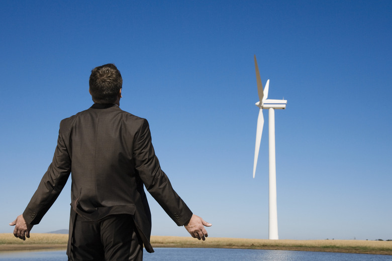 Rear view of man standing near turbine