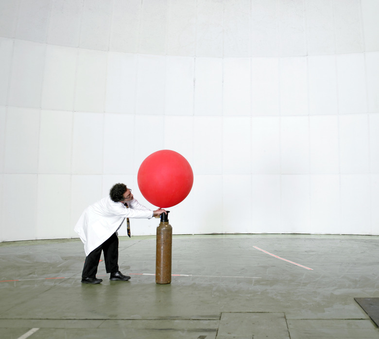 Scientist blowing up weather balloon with air