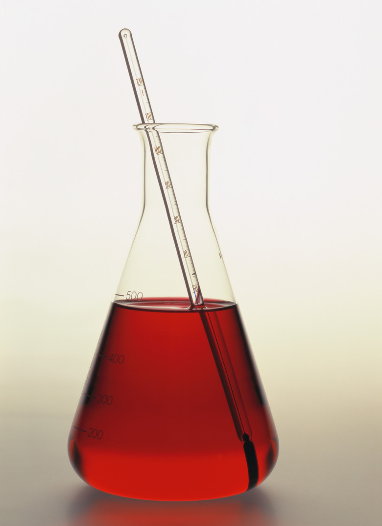 close-up of a flask containing red fluid with a thermometer in it