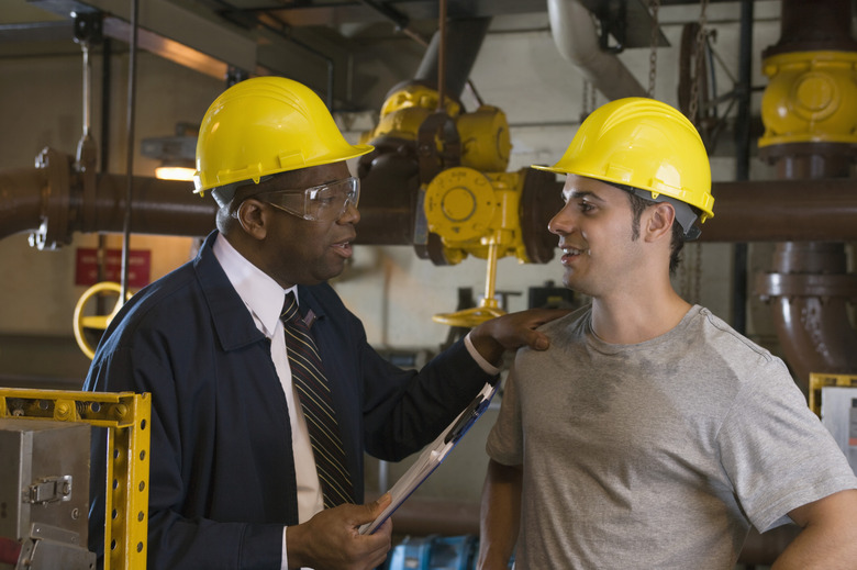 Manager and worker in waste treatment plant