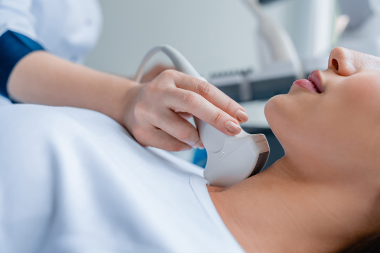 Close up of doctor conducting ultrasound examination of woman in clinic