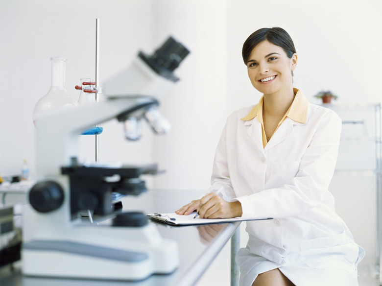 portrait of a female scientist writing on a clipboard