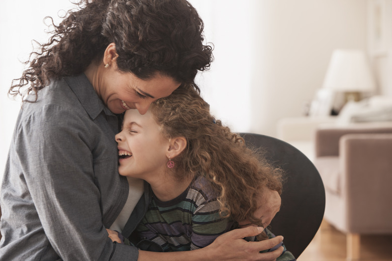 Hispanic mother and daughter hugging