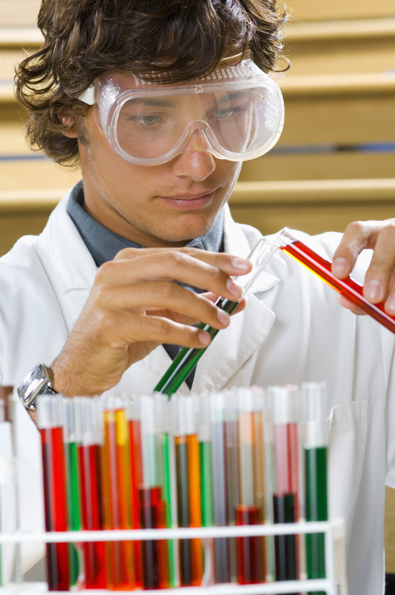 Boy pouring mixture from test tube