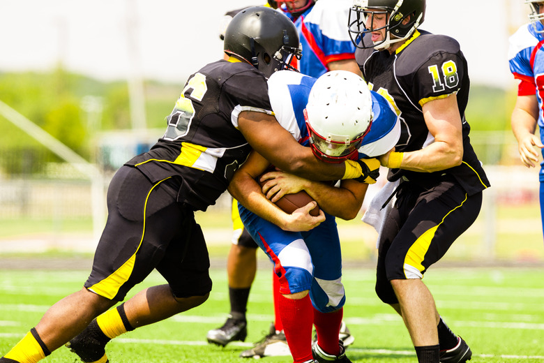 Football running back being tackled