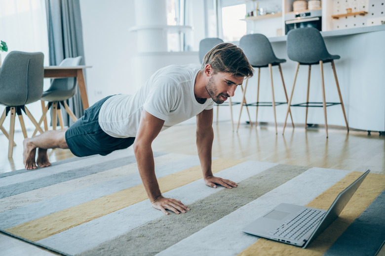 Young man exercising at home.