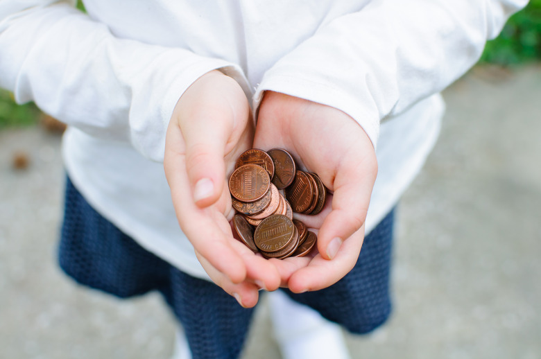 Child holding a handful of pennies