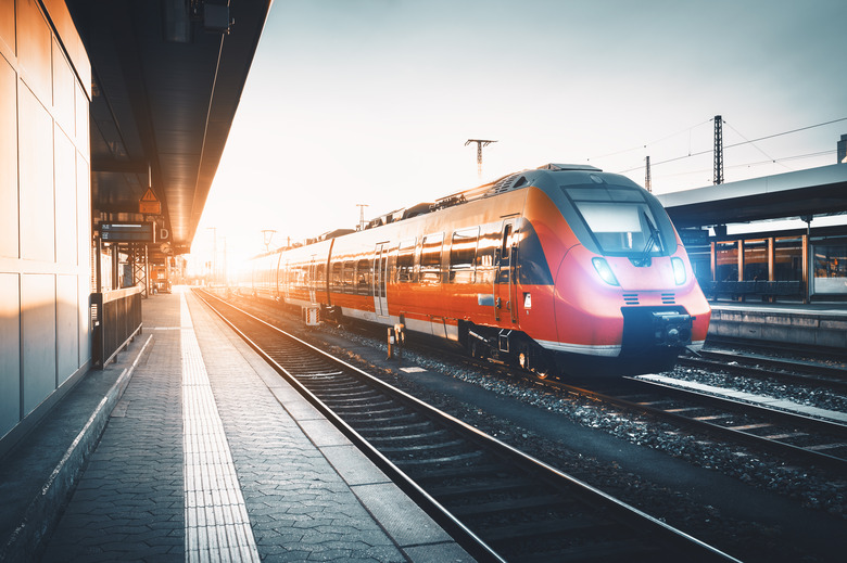 Modern high speed red commuter train at the railway station