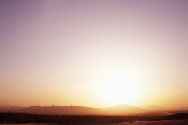 Landscape shot of sun coming down over the mountains in the desert, clear sky, China