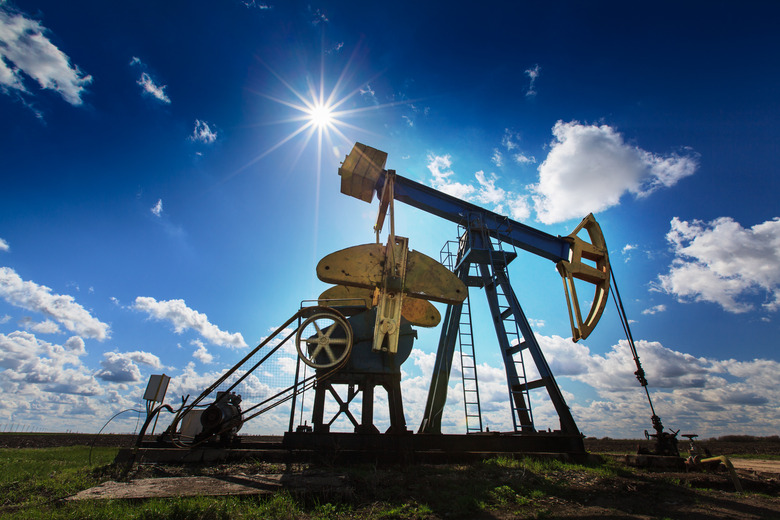 An oil and gas well against a sunny sky