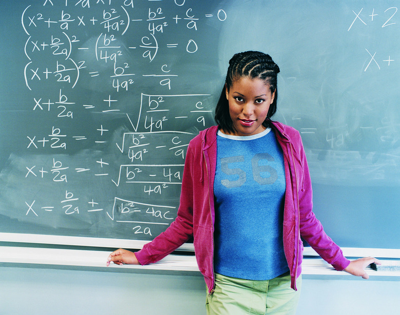 Portrait of Female Student Standing in front of Blackboard