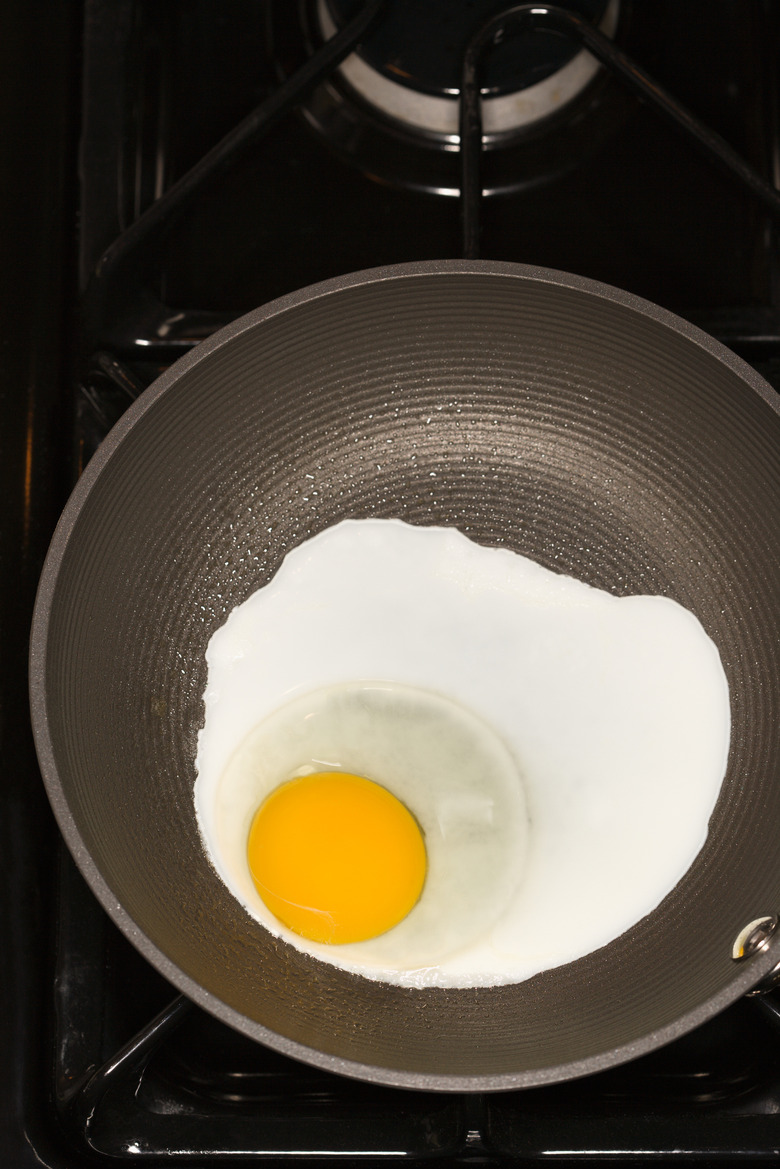 Egg cooking in frying pan