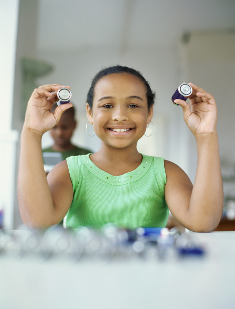 portrait of a girl holding a battery