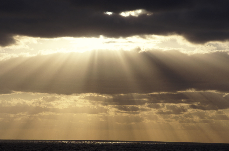 Norway, sunbeams shining through stormy clouds, golden