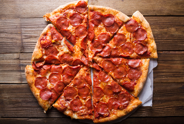 Pizza salami on wooden background