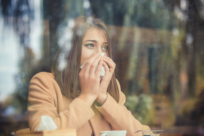 Young woman got nose allergy, flu sneezing nose